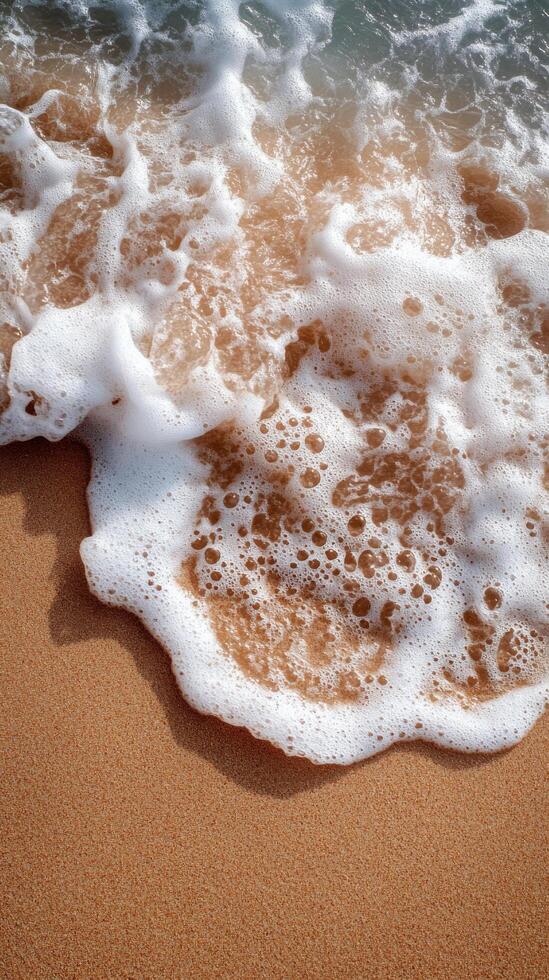 Gentle waves touch sandy shore with smooth stones on a sunny day at the beach photo