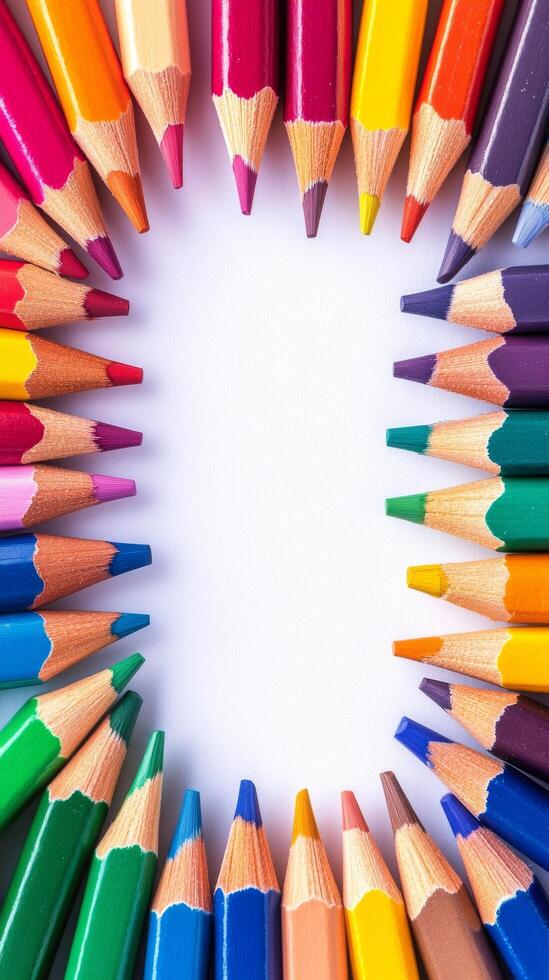 Brightly colored pencils arranged in a circular pattern on a white background for creative projects photo