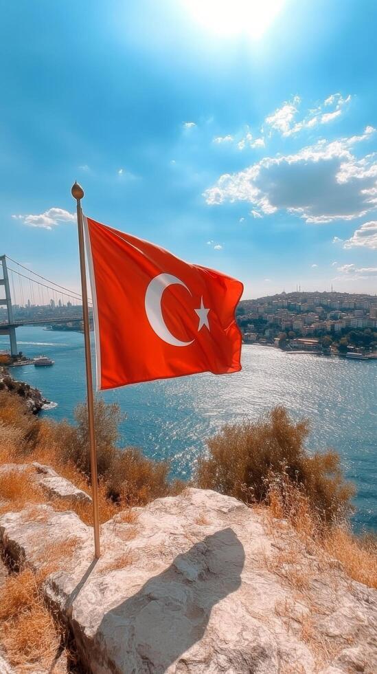 Turkish flag waving on a boat in the Bosphorus with stunning skies and bridge in the background photo