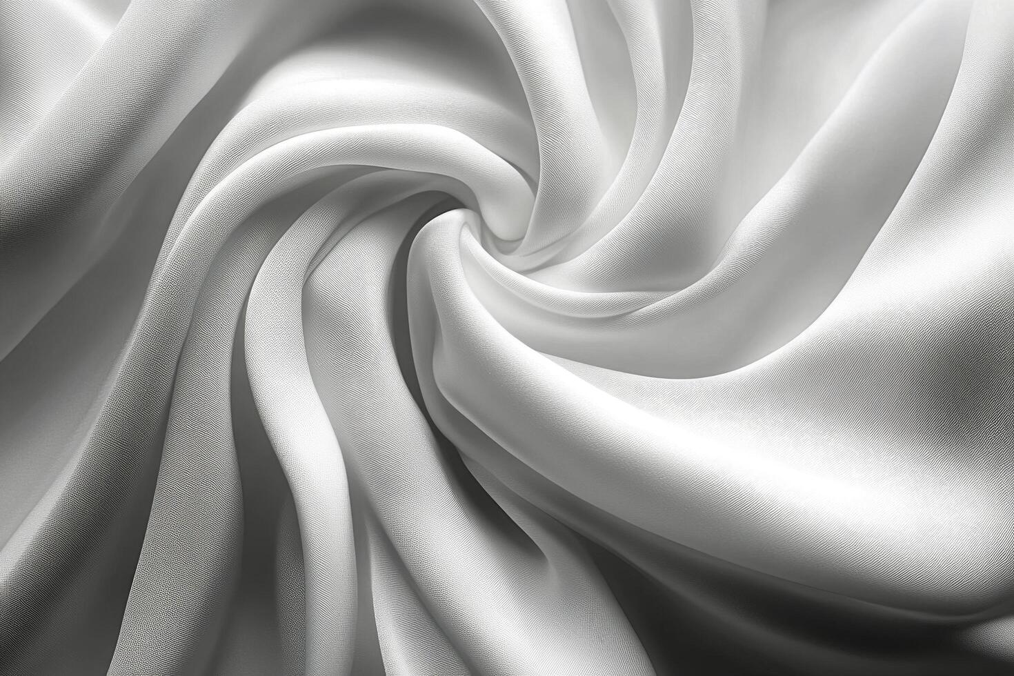 Smooth white fabric swirling in a spiral pattern with soft textures illuminated by gentle light photo