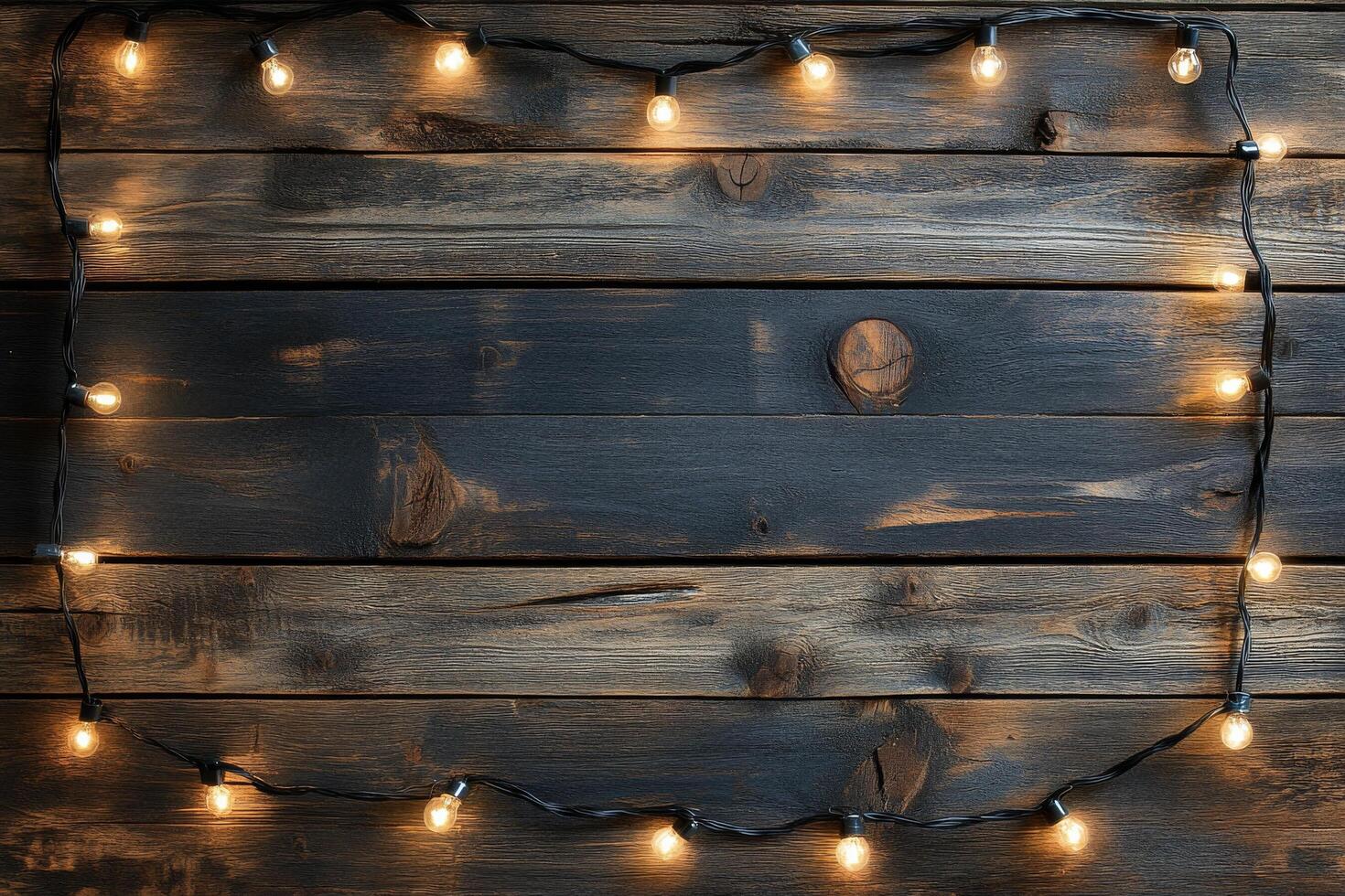 Decorative lights and pine branches on dark wooden surface during evening ambiance photo
