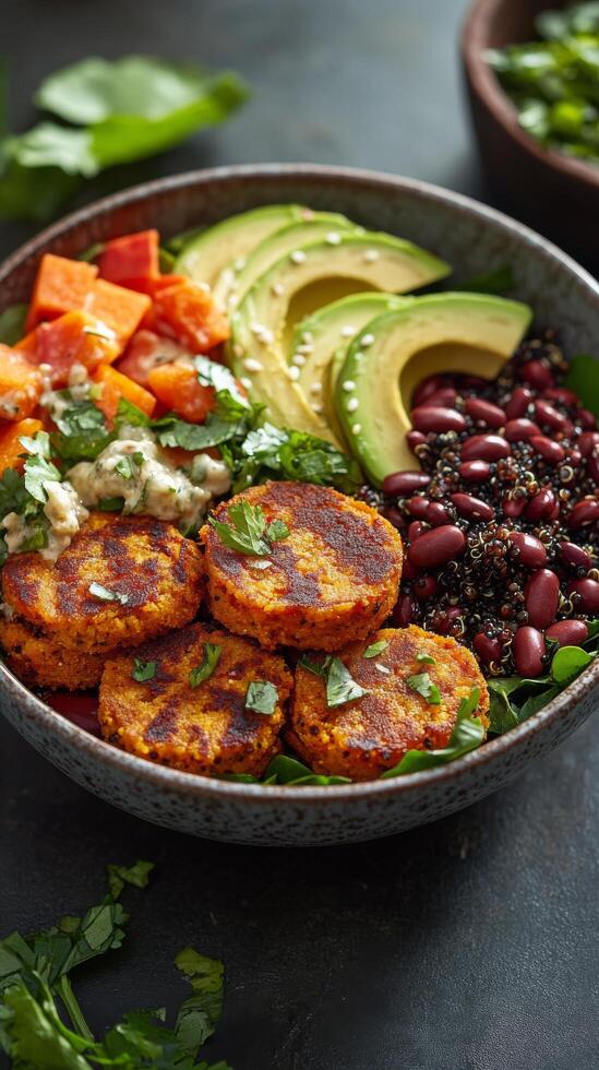 Delicious vegetable patties served with fresh greens and colorful toppings in a modern bowl photo