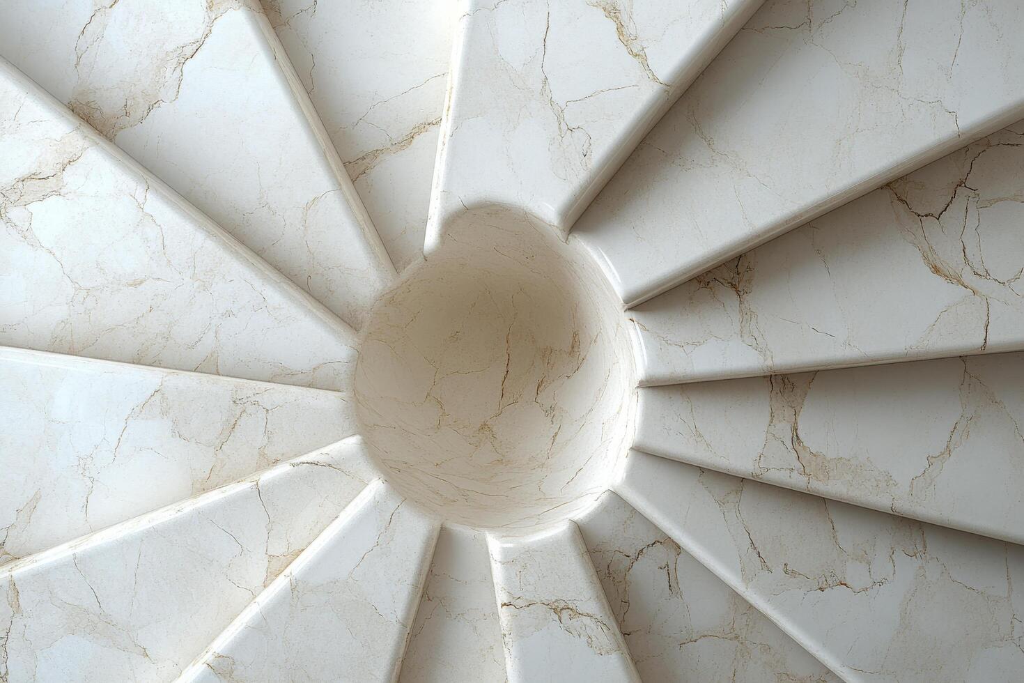 Elegant spiral staircase captured from above in a historic building with intricate design details photo
