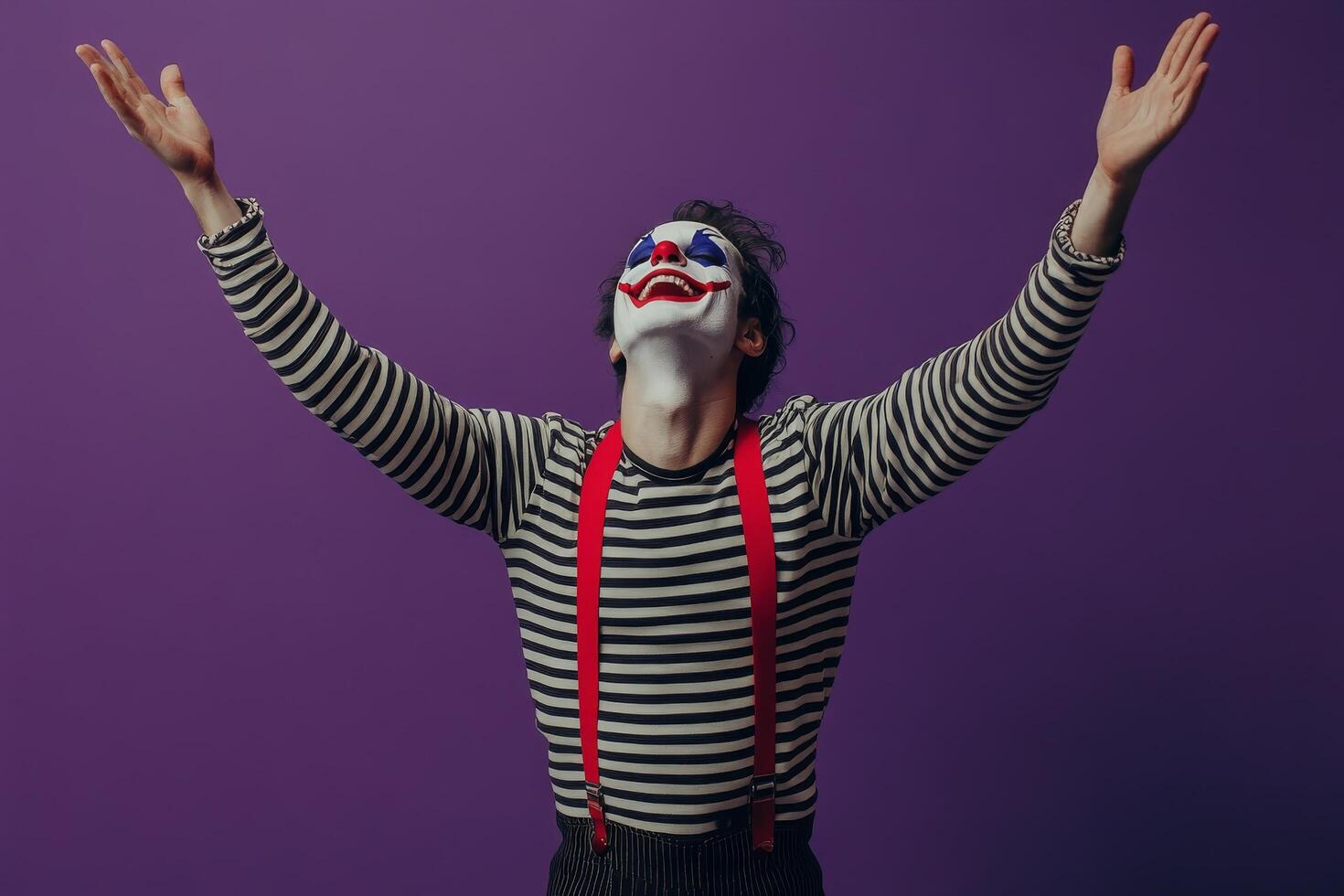A performer dressed as a clown presents an entertaining act against a vibrant purple backdrop photo