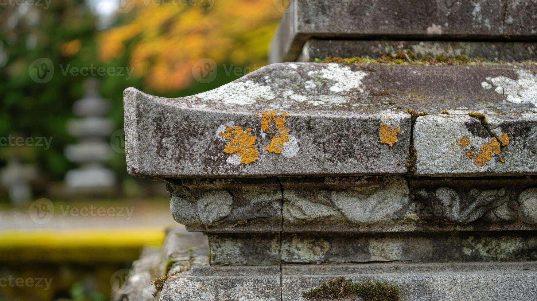 Closeup of an Ornate Stone Structure with Yellow Lichen photo