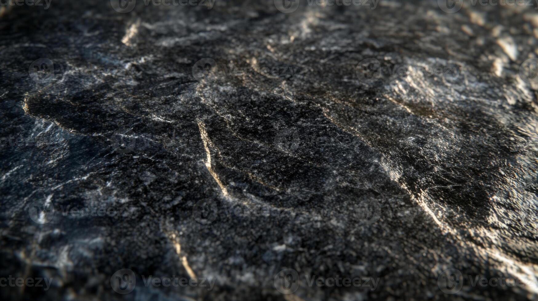 Close-up of Dark Grey Rock Surface with Veins and Texture photo