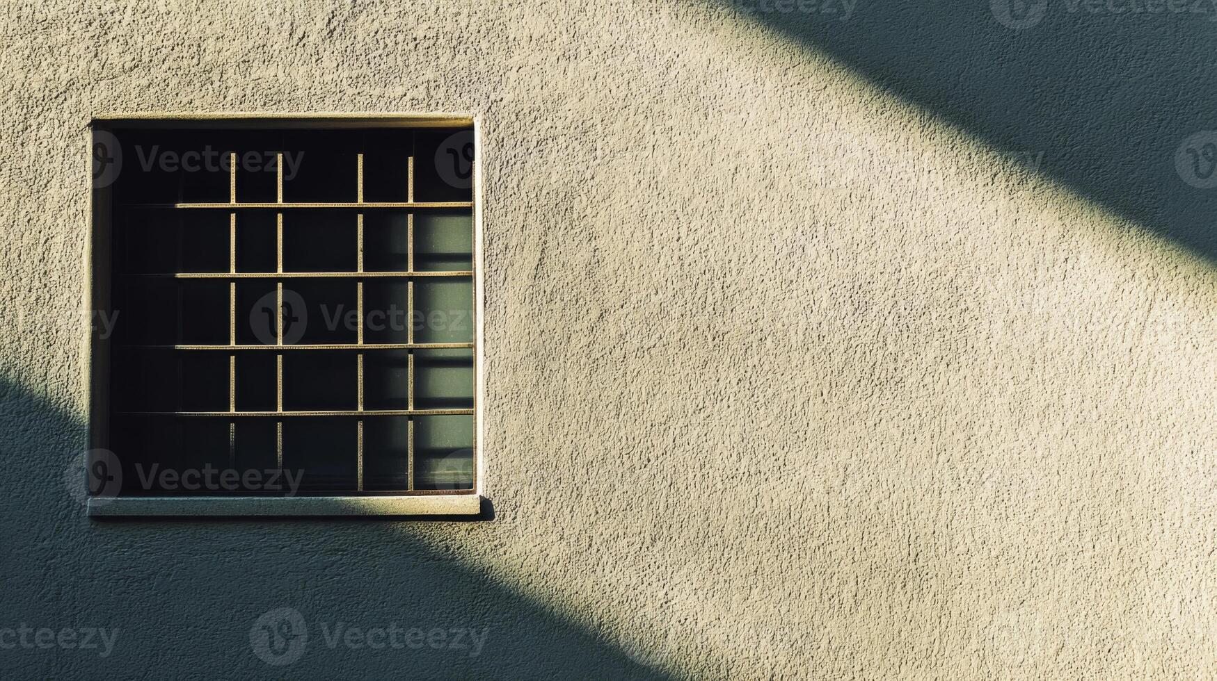 A Single Window with Bars on a Tan Wall photo