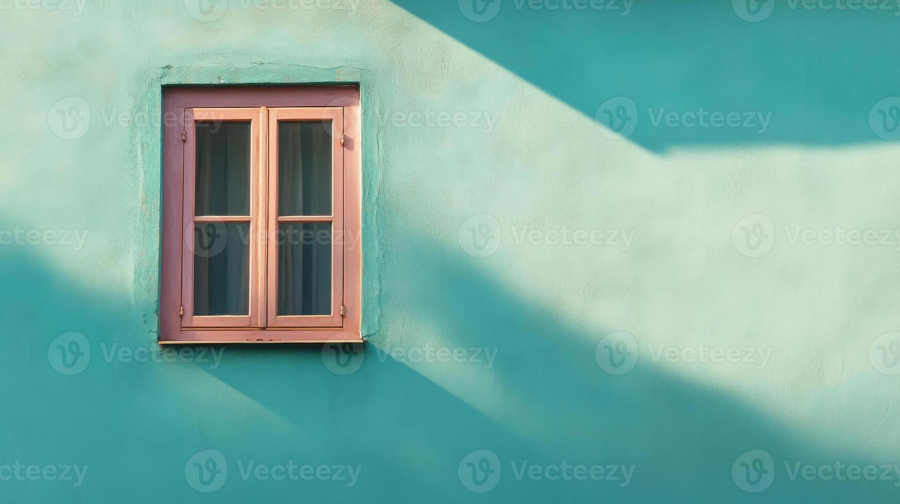 A Single Window on a Turquoise Wall with Shadows photo