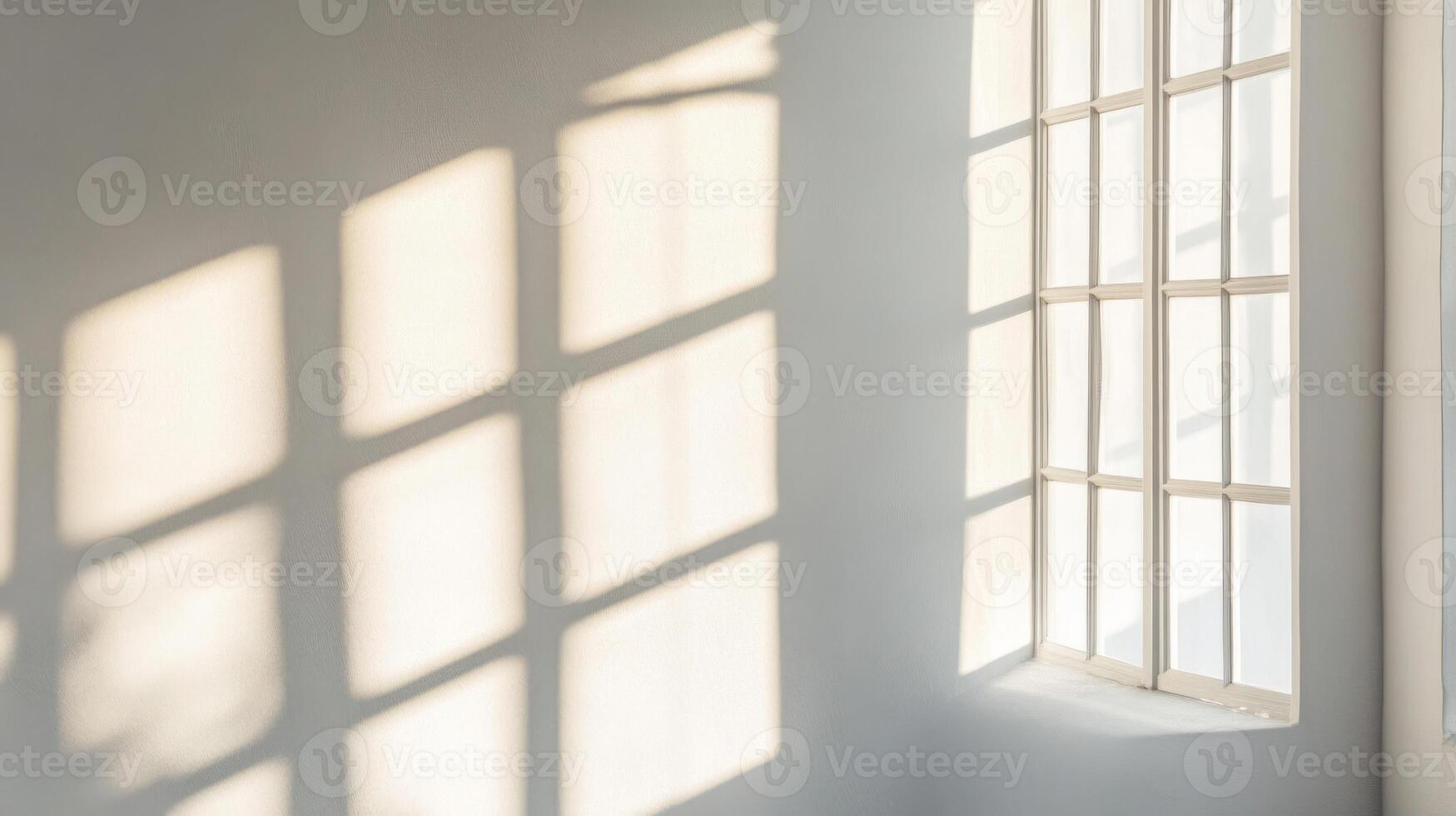 Sunlit Window Casting a Geometric Shadow on a White Wall photo