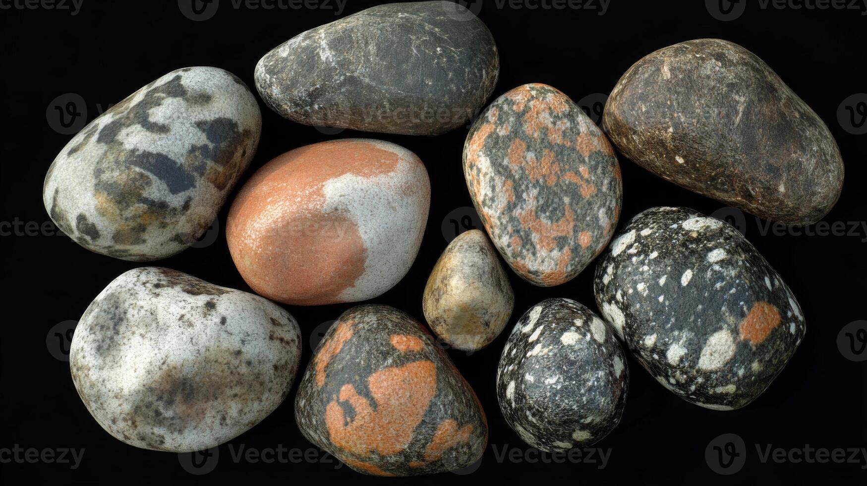 Collection of Smooth, Multicolored Pebbles on a Black Background photo