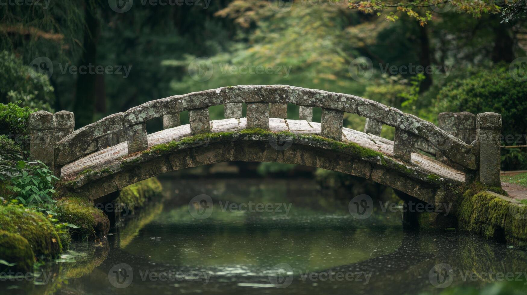Moss-Covered Stone Bridge Spanning a Tranquil Pond photo