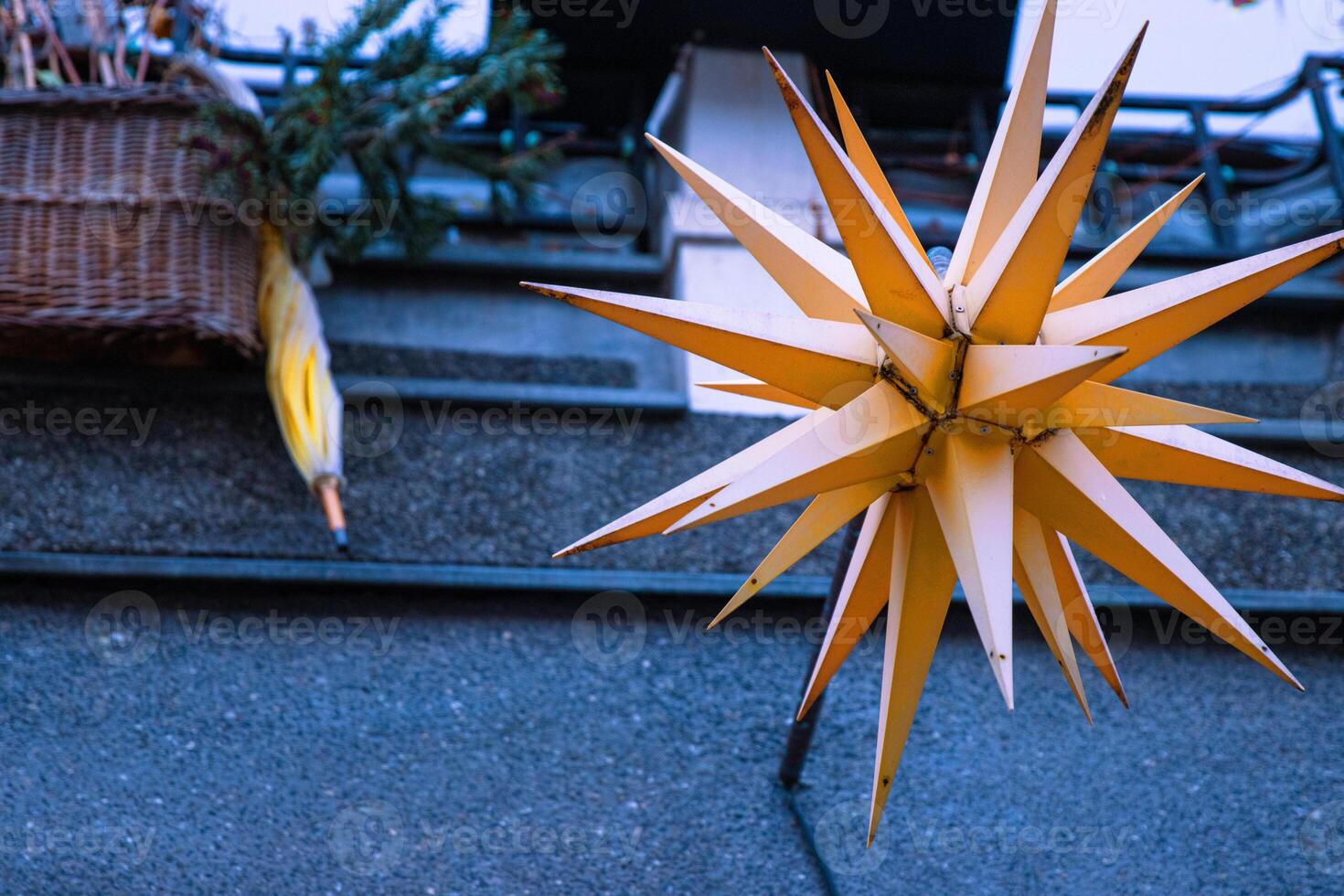 Closeup of a handmade Waldorf star crafted from paper hangs beautifully on a window during the Christmas season, bringing warmth and a cozy, festive atmosphere. photo