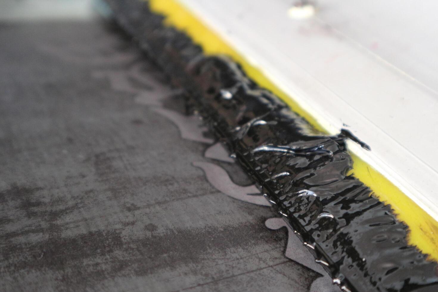 A black and yellow strip of tape on the floor photo