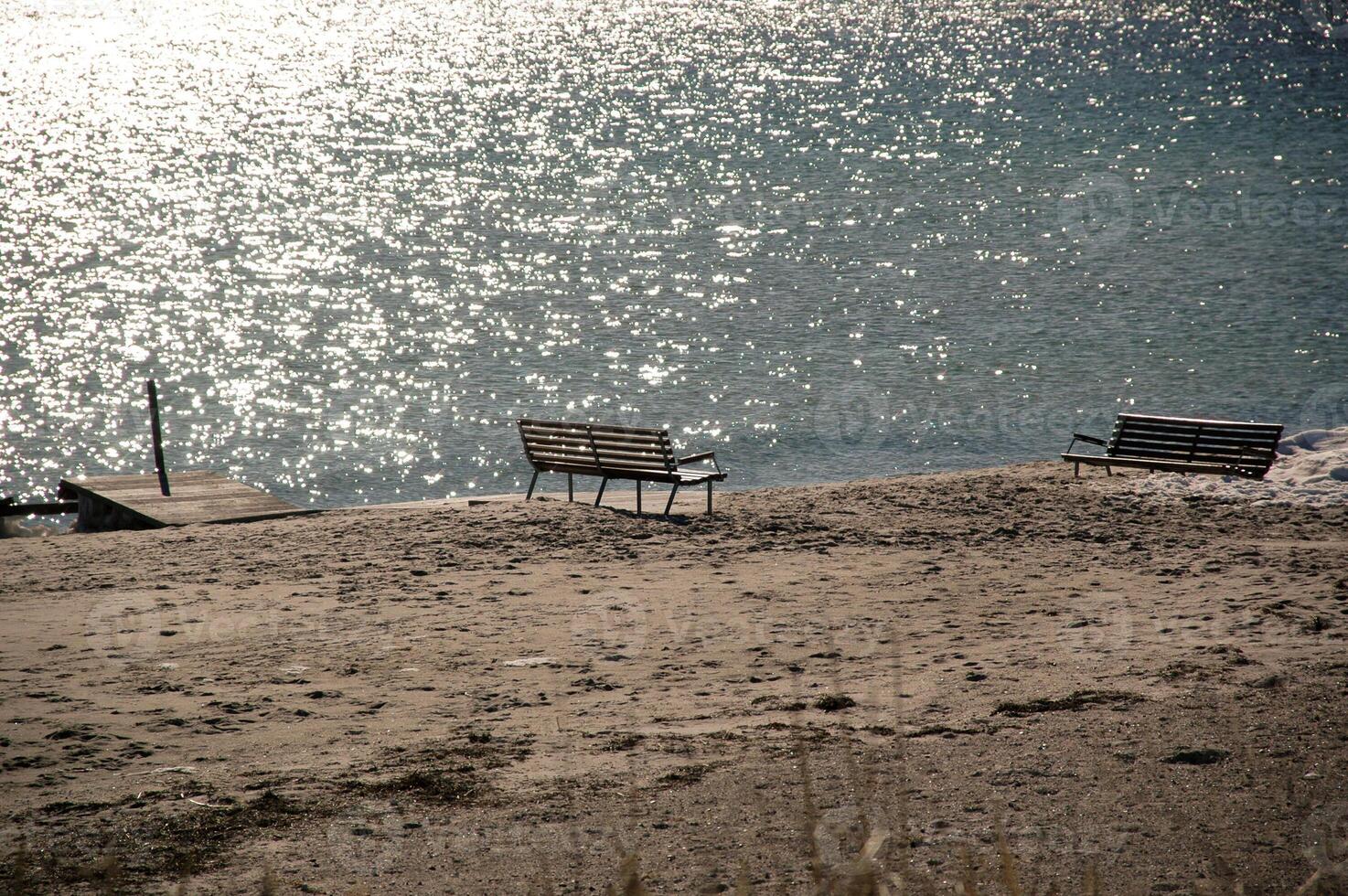 Empty benches by the beach photo