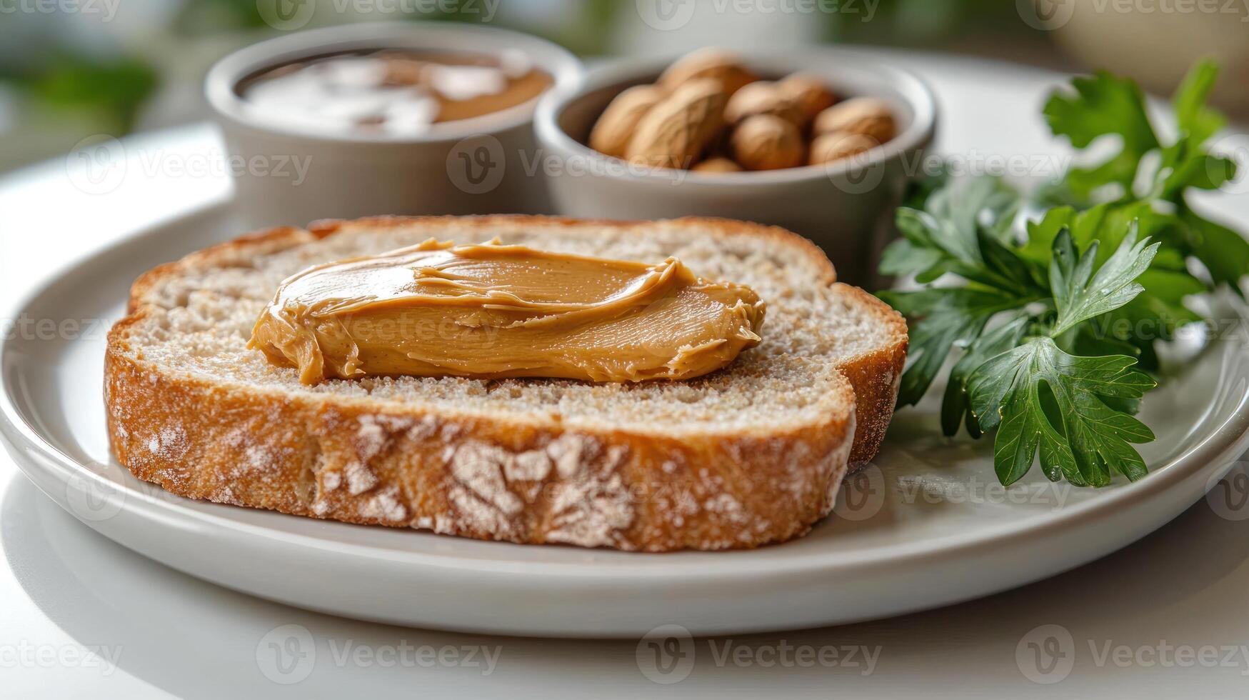 Whole grain bread with peanut butter accompanied by nuts and green herbs on a plate photo