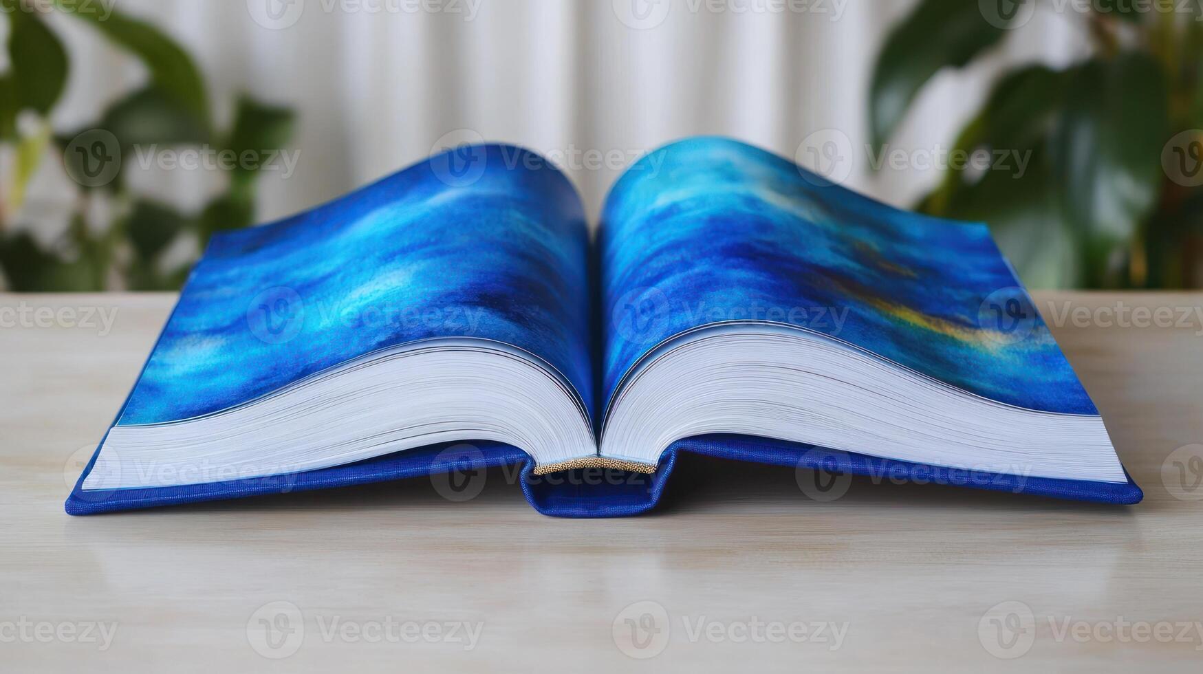 The open book showcases an artistic blue design, inviting curiosity and contemplation photo
