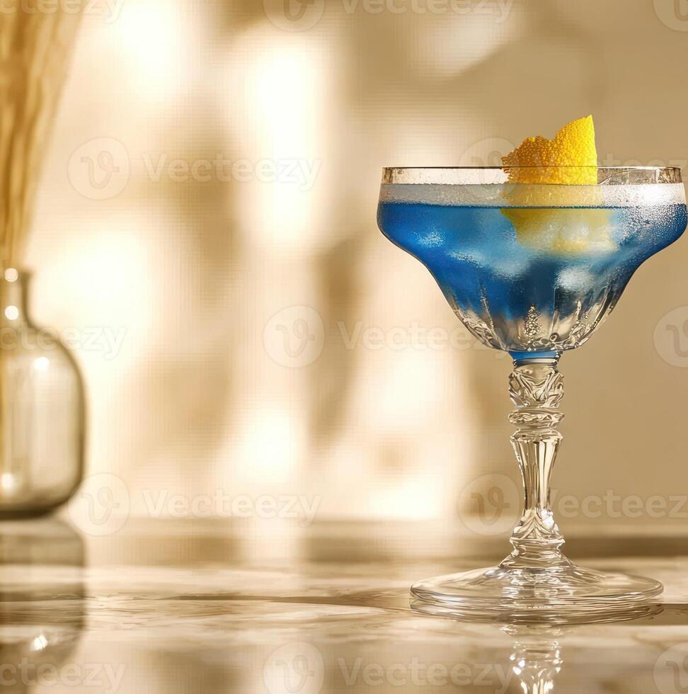 A refreshing blue cocktail with a lemon garnish sparkles in the warm afternoon sunlight photo