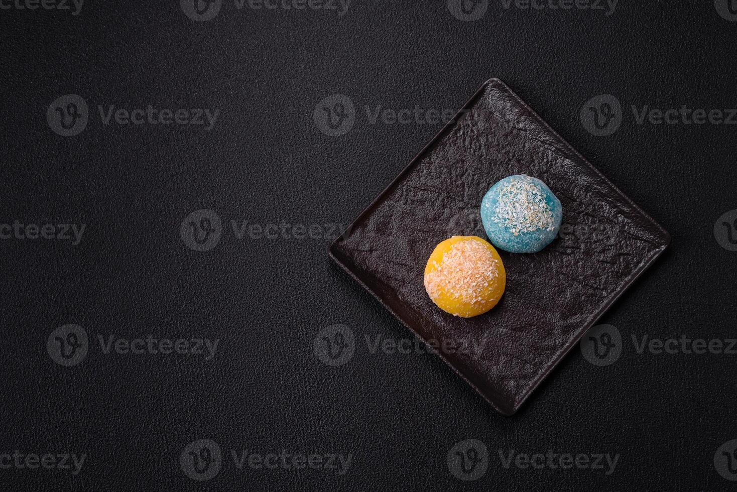 Delicious colorful asian mochi sweets with rice dough shell and fruit filling photo