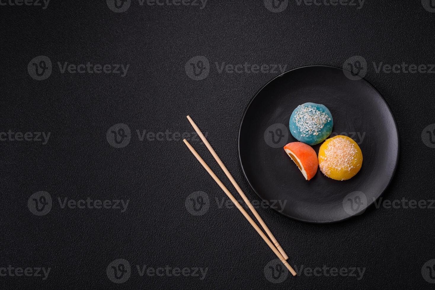 Delicious colorful asian mochi sweets with rice dough shell and fruit filling photo