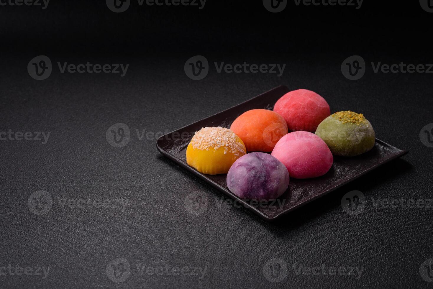 Delicious colorful asian mochi sweets with rice dough shell and fruit filling photo