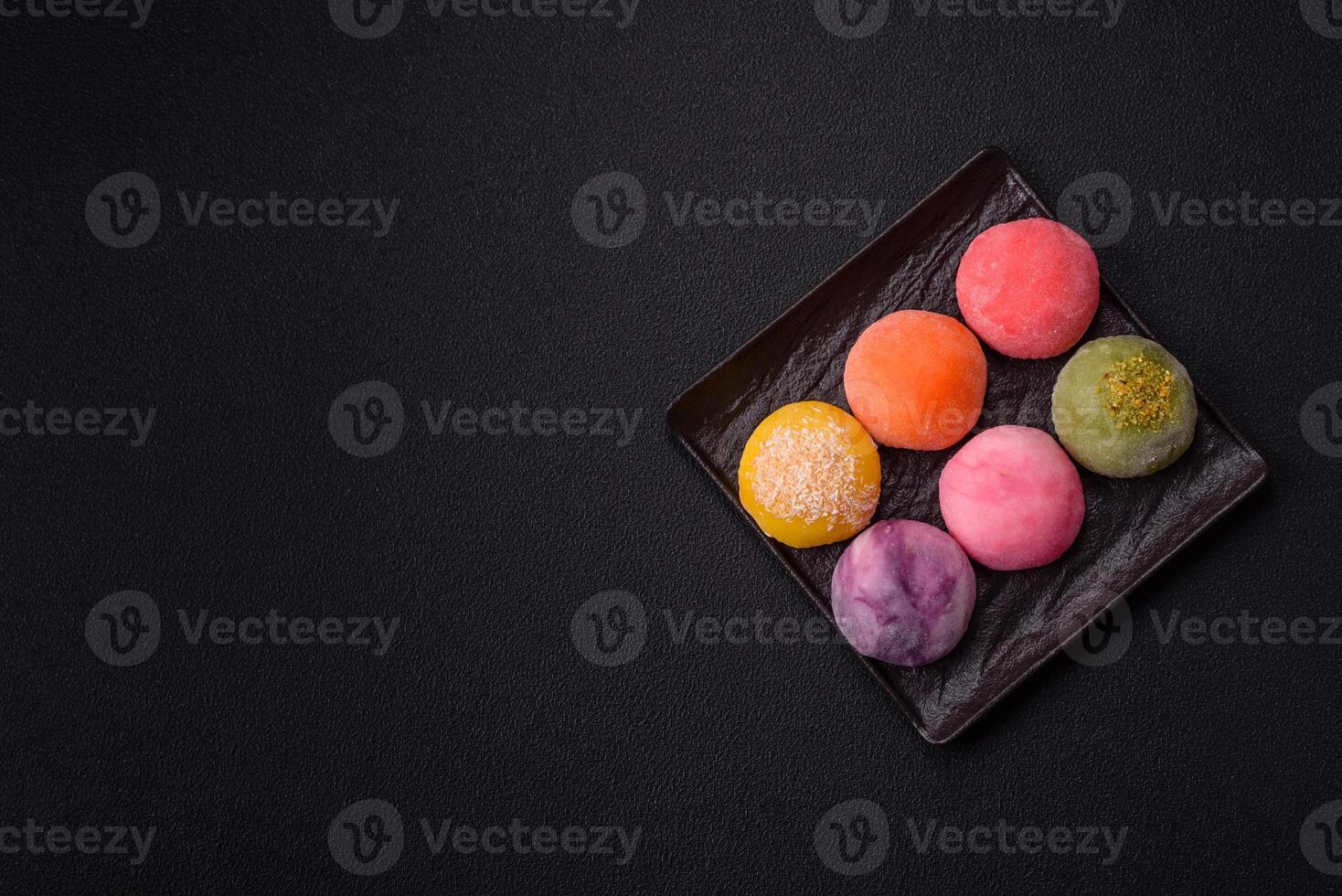Delicious colorful asian mochi sweets with rice dough shell and fruit filling photo