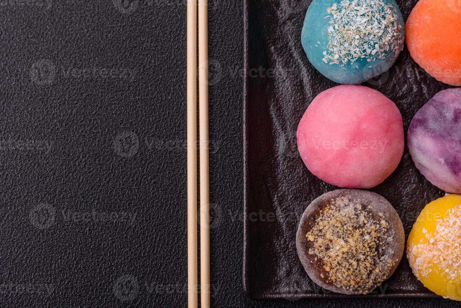 Delicious colorful asian mochi sweets with rice dough shell and fruit filling photo