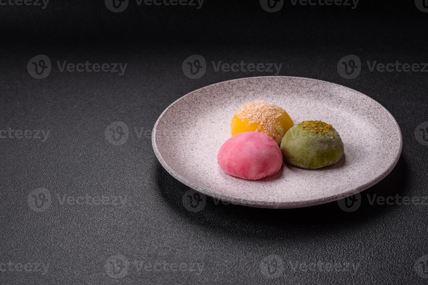 Delicious colorful asian mochi sweets with rice dough shell and fruit filling photo
