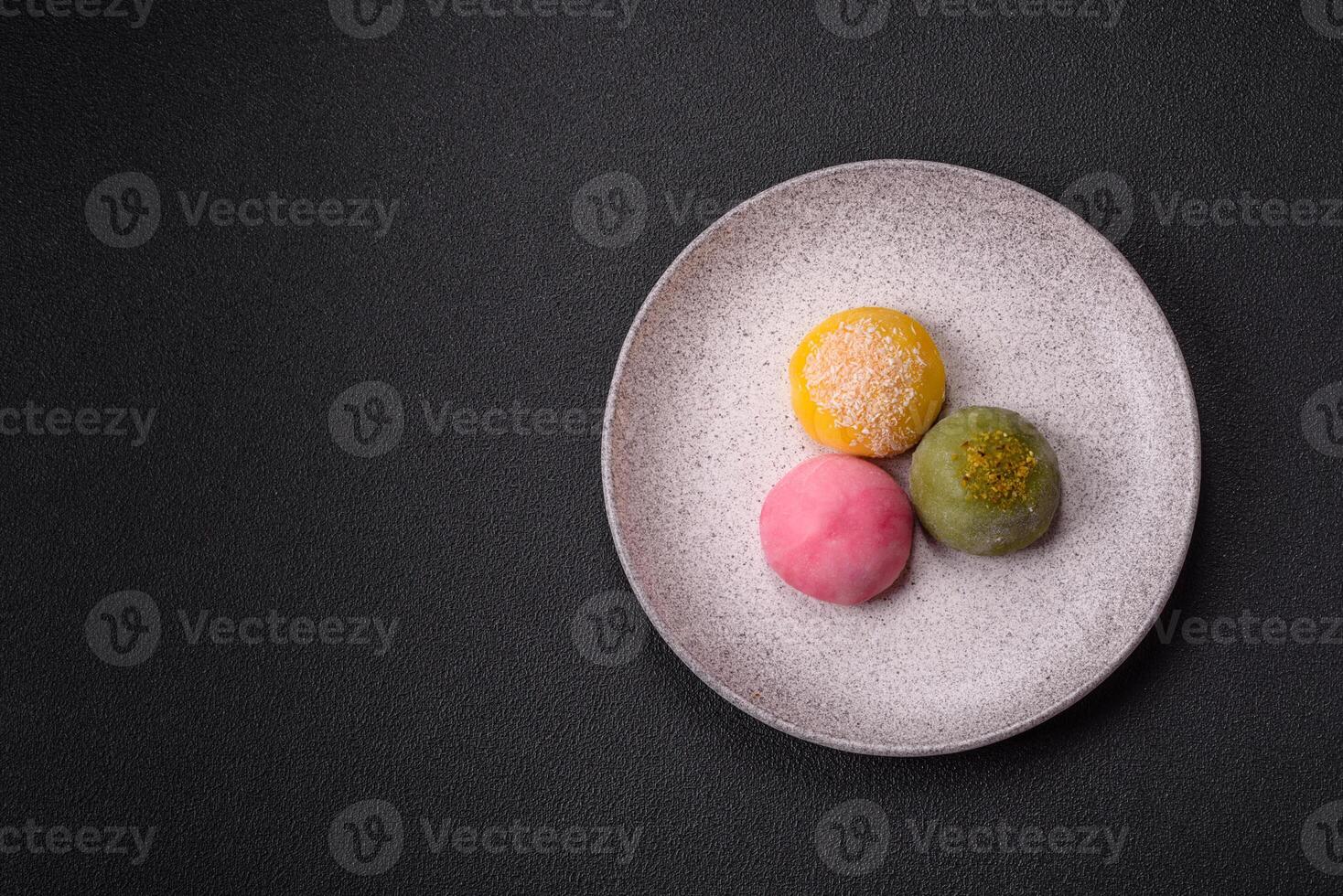 Delicious colorful asian mochi sweets with rice dough shell and fruit filling photo