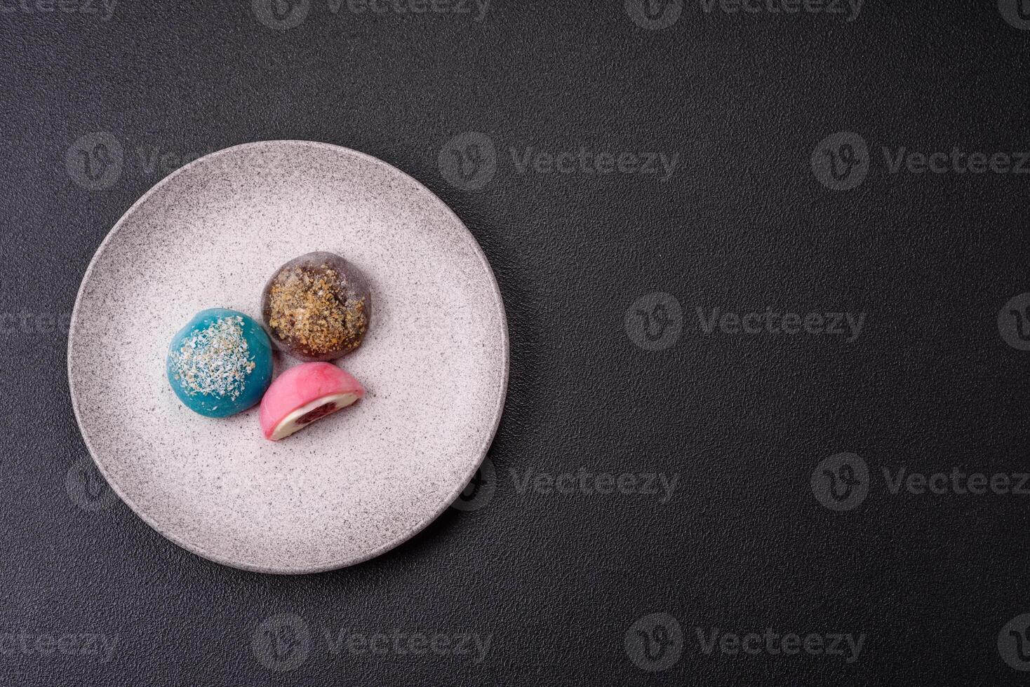 Delicious colorful asian mochi sweets with rice dough shell and fruit filling photo