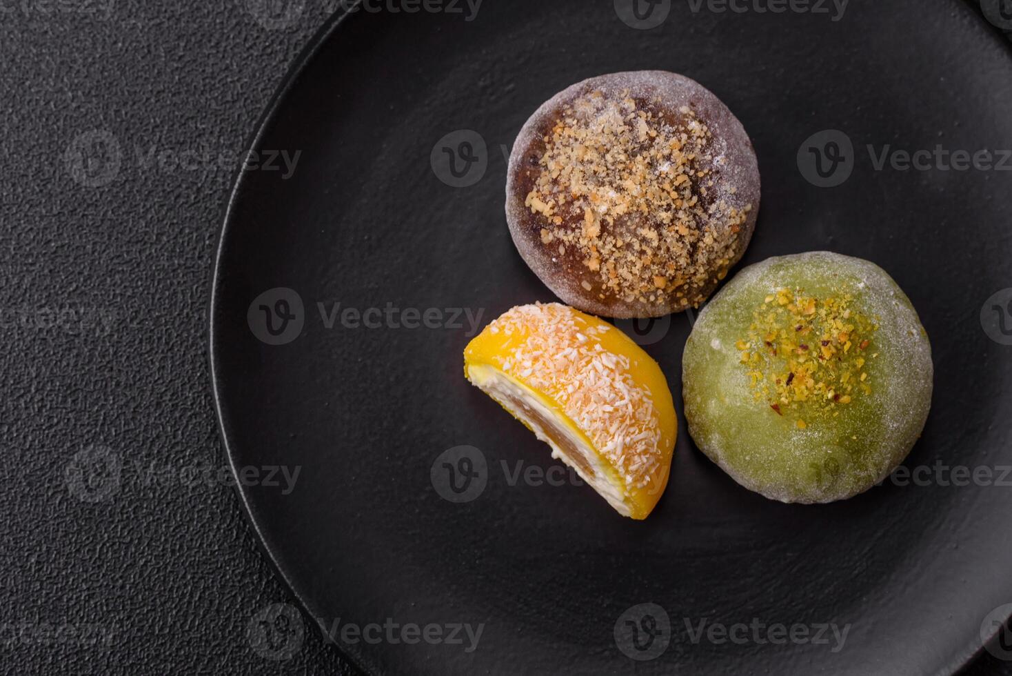 Delicious colorful asian mochi sweets with rice dough shell and fruit filling photo