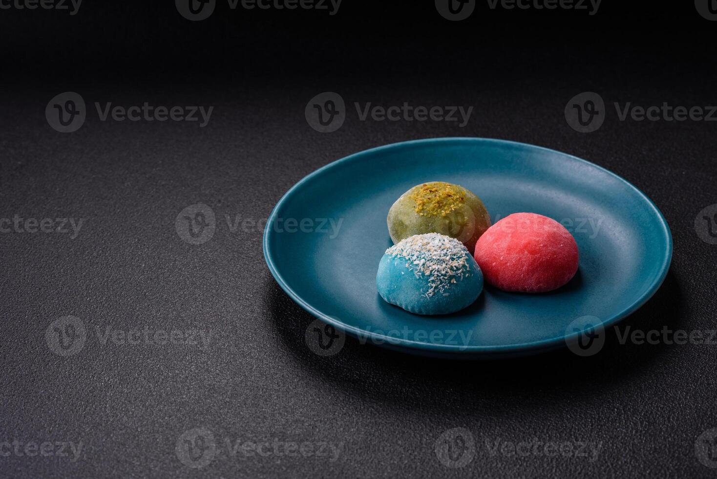 Delicious colorful asian mochi sweets with rice dough shell and fruit filling photo