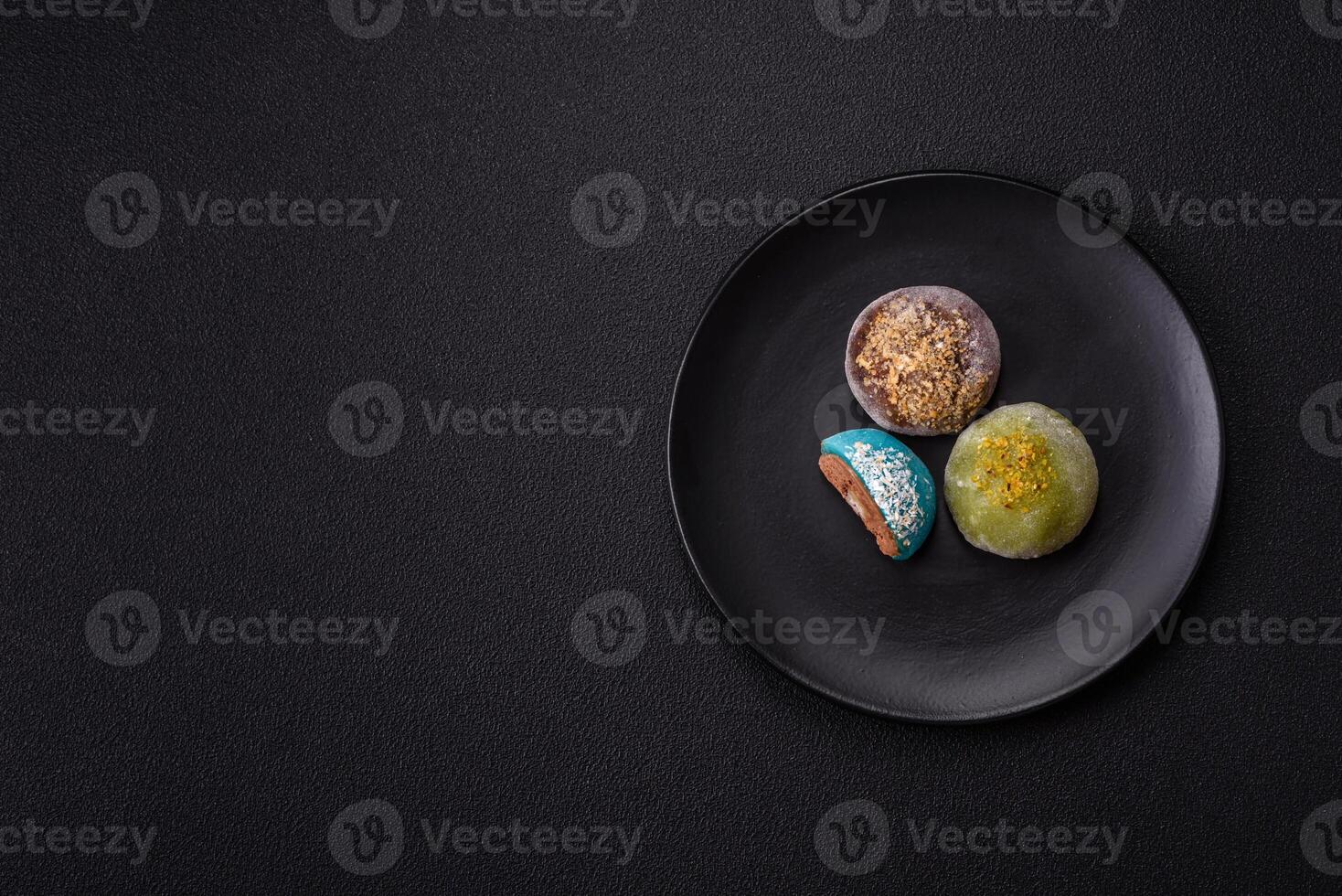 Delicious colorful asian mochi sweets with rice dough shell and fruit filling photo