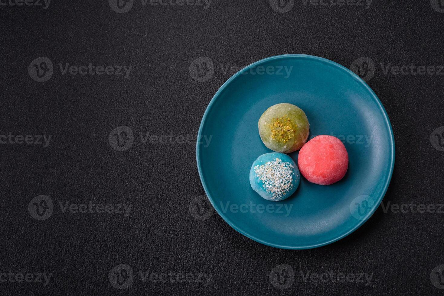 Delicious colorful asian mochi sweets with rice dough shell and fruit filling photo