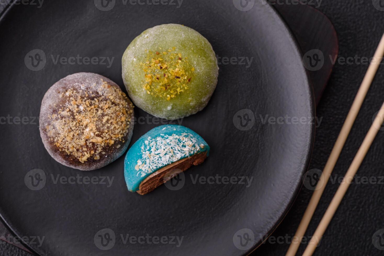 Delicious colorful asian mochi sweets with rice dough shell and fruit filling photo