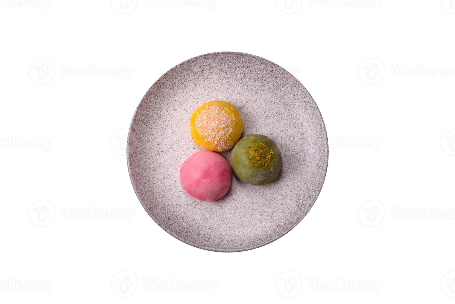 Delicious colorful asian mochi sweets with rice dough shell and fruit filling photo