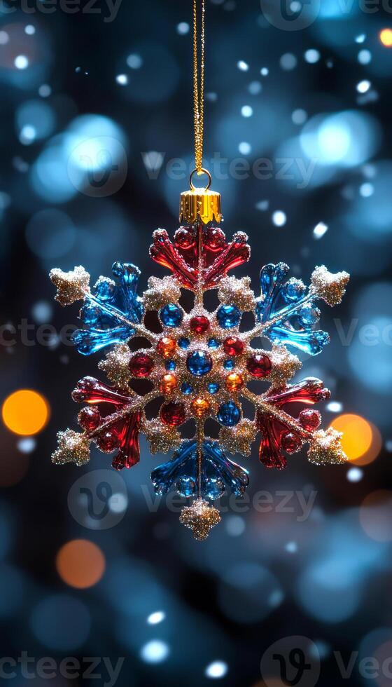 A snowflake ornament with blue, red, and gold beads hanging from a chain. The snowflake is suspended in the air, surrounded by a blurry background. Concept of warmth and holiday cheer photo