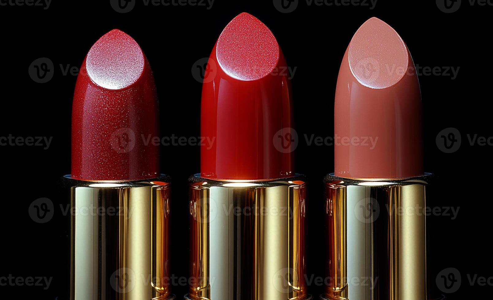 Three red lipsticks are displayed side by side. The lipsticks are all different shades of red, with one being a darker shade than the other two. The lipsticks are arranged in a row photo