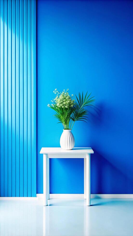 A white table with a vase of flowers in front of a blue wall photo