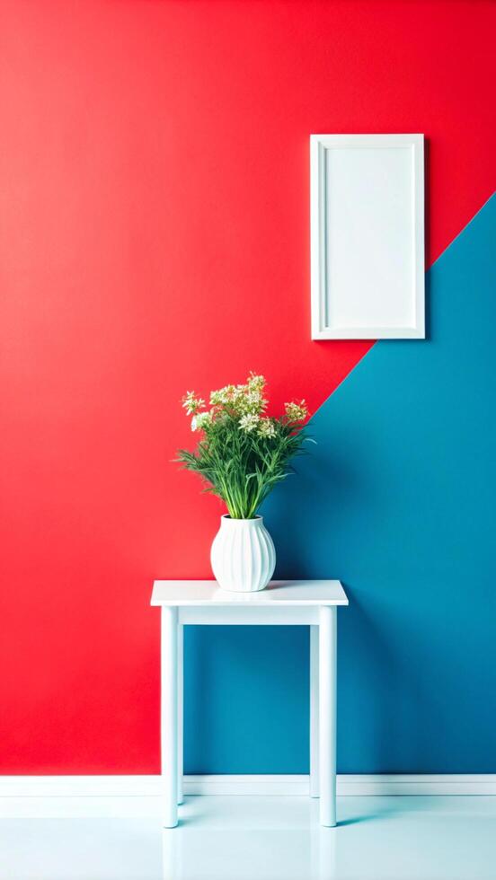 A white table with a vase of flowers in front of a red and blue wall photo