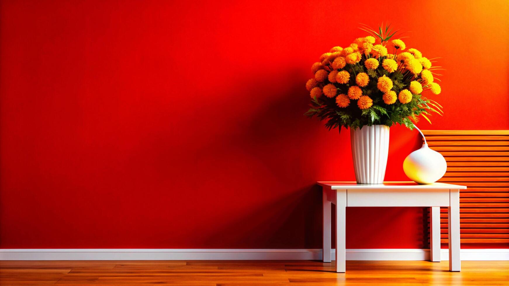 A vase of flowers sits on a table next to a red wall photo