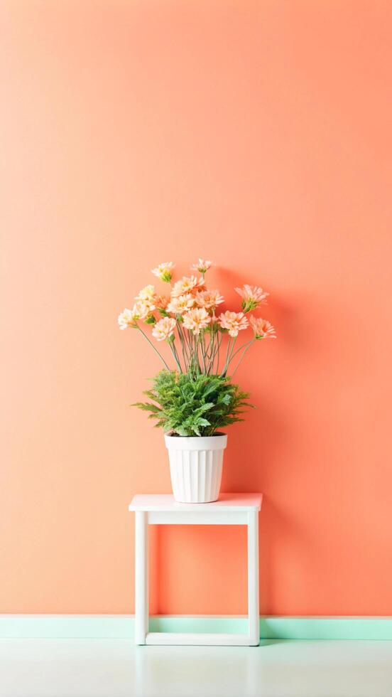 A flower pot on a table in front of an orange wall photo