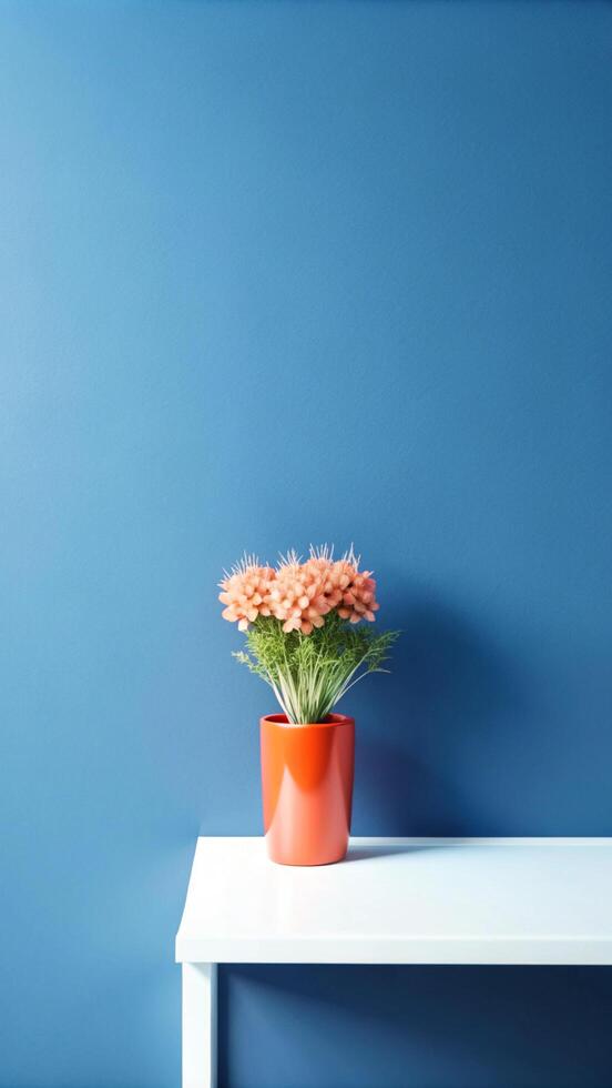 A vase of flowers on a table in front of a blue wall photo