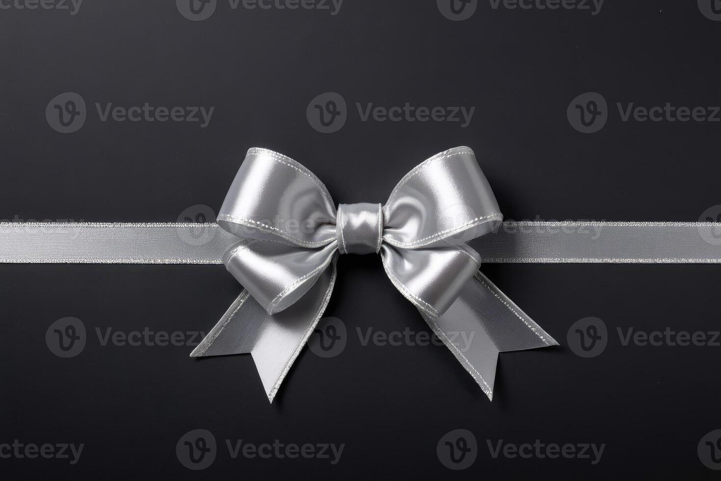 decorative ribbon bow silver string black background photo