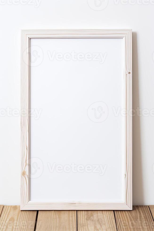 Blank white wooden frame on wooden table photo