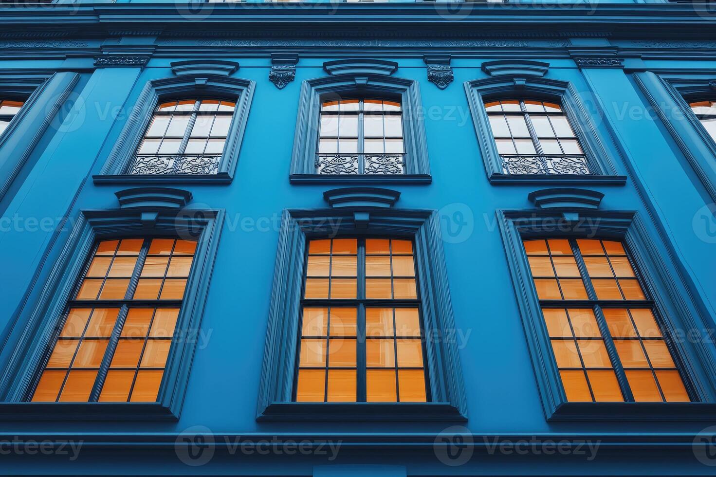 Elegant classical european building facade with arched windows reflecting sky photo