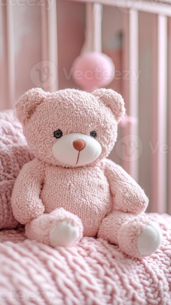 Teddy bear sitting on a cot in a pink bedroom for baby girl photo