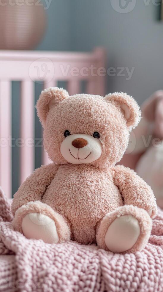 Teddy bear sitting on a cot in a pink bedroom for baby girl photo