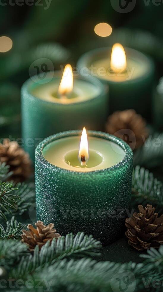 Burning green candles creating festive christmas atmosphere with pine branches and pine cones photo