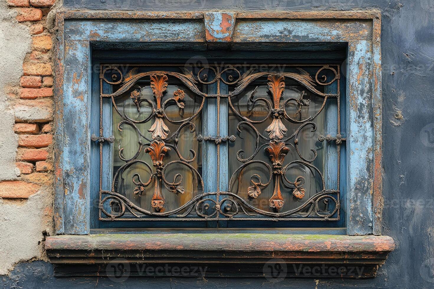 Old window with rusted iron grille reflecting buildings in a european city photo