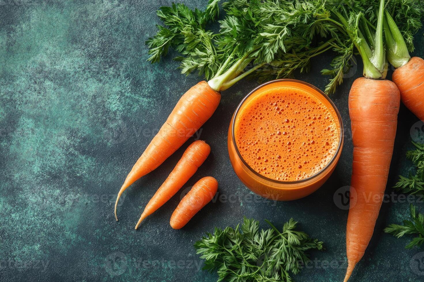Glass of freshly squeezed carrot juice with carrots on dark background photo